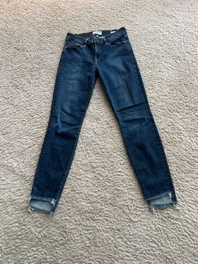 Frame Le High Skinny Jeans medium blue wash with distinctive raw fringed hem